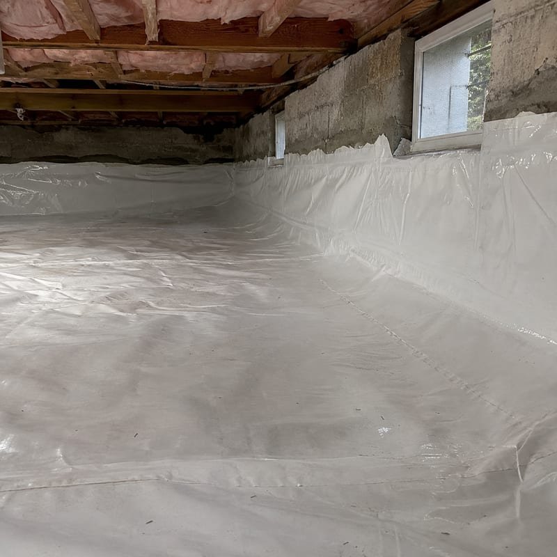 Heavy-mil vapor barrier installed over crawl space soil in a Rochester, NY home